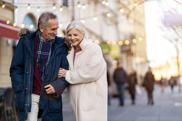 Senior couple walking on the city street at winter day Senior couple walking on the city street at winter day