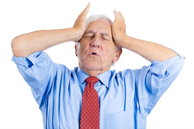 Stressed worried old man having headache