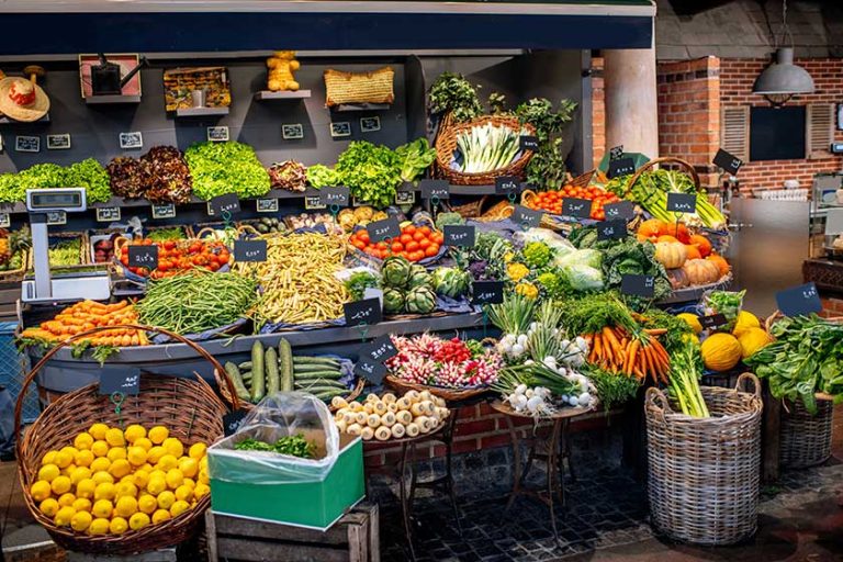 Variety of beautifully organized fruits and vegetables on the counter of the market place Variety of beautifully organized fruits and vegetables on the counter of the market place