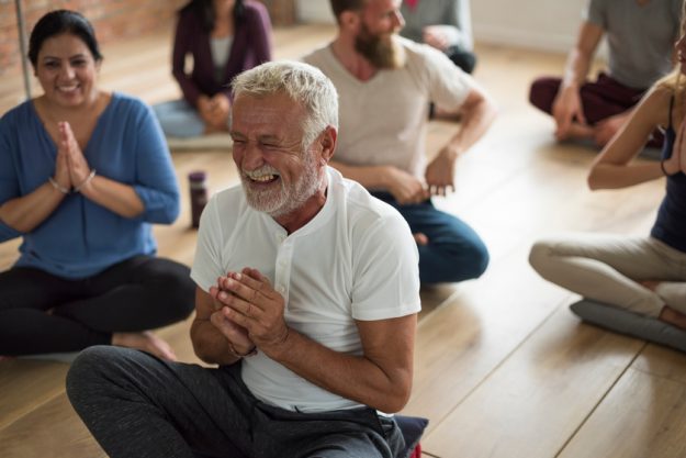 Happy senior man in a yoga class 4 Breathing Exercises To Keep Your Lungs Healthy