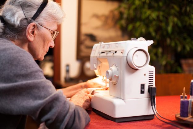 old woman sewing 4 Cognitive Benefits Of Sewing For Your Aging Mom