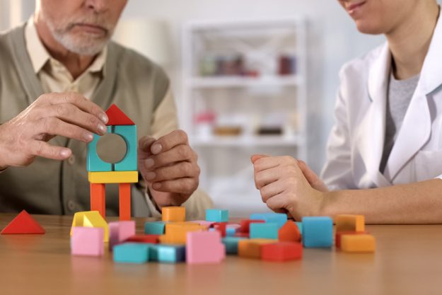 Psychologist mentoring senior male, training to identify problem