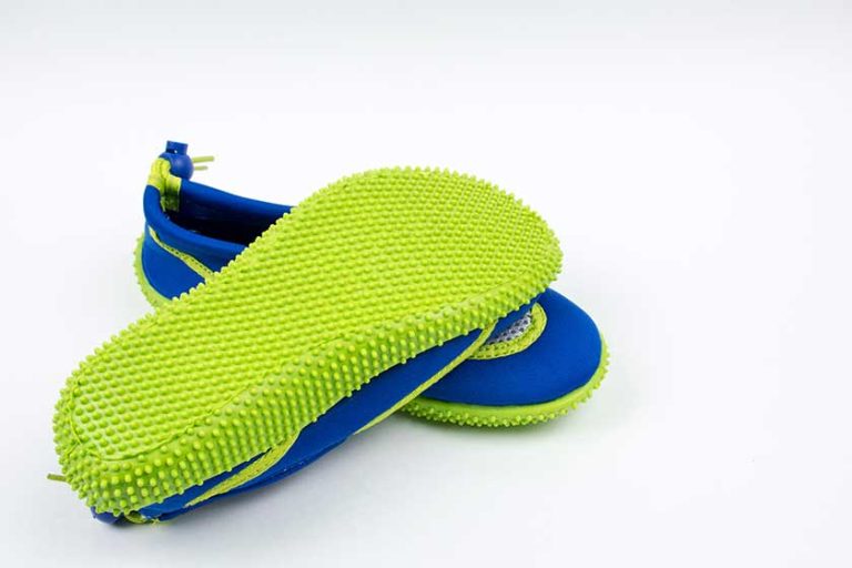 A pair of children's shoes for with an anti-slip sole for swimming in the pool.