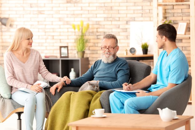 Caregiver with senior man and his daughter at home Choosing A Suitable Floor Plan For Your Senior Home In Florida