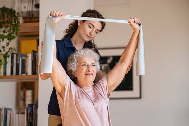 Senior patient doing exercise with elastic band