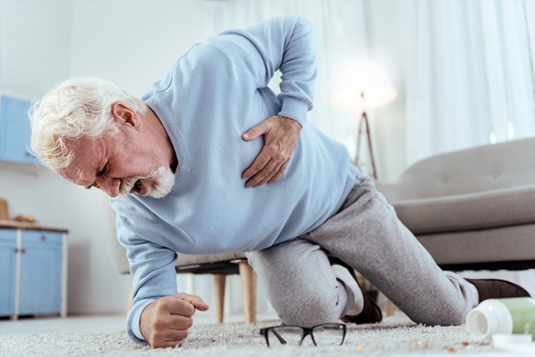 Severe pain. Low angle of shocked senior man shouting