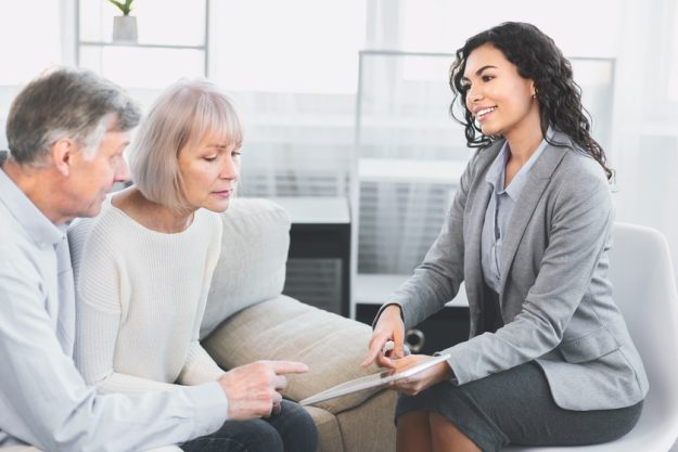Mature couple consulting with adviser at office The Best Floor Plans For Senior Apartments In New Braunfels, TX