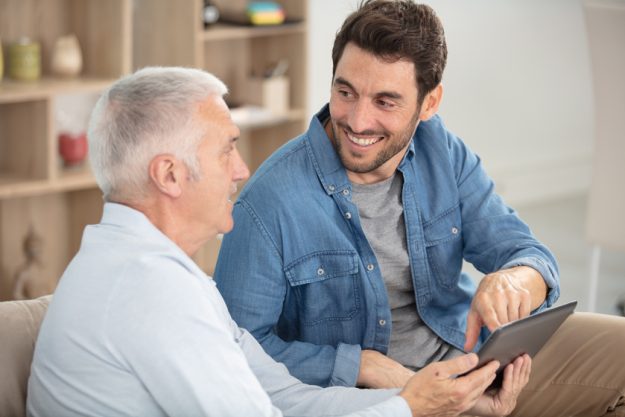 senior father with adult son talking about finance 3 Mistakes To Avoid When Talking To Parents About Moving To Bexar County, TX Assisted Living