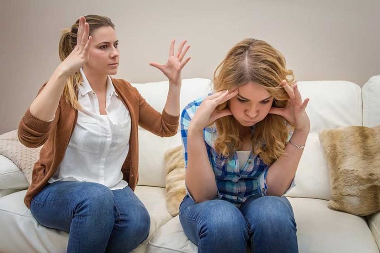 Furious mother arguing with her teenage daughter Furious mother arguing with her teenage daughter