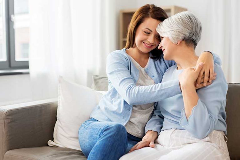 happy smiling senior mother with adult daughter hugging at home happy smiling senior mother with adult daughter hugging at home