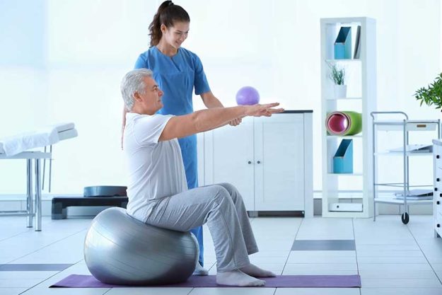 Physiotherapist working with patient in clinic Physiotherapist working with patient in clinic