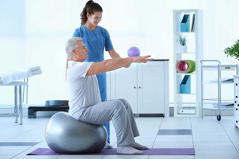 Physiotherapist working with patient in clinic Physiotherapist working with patient in clinic