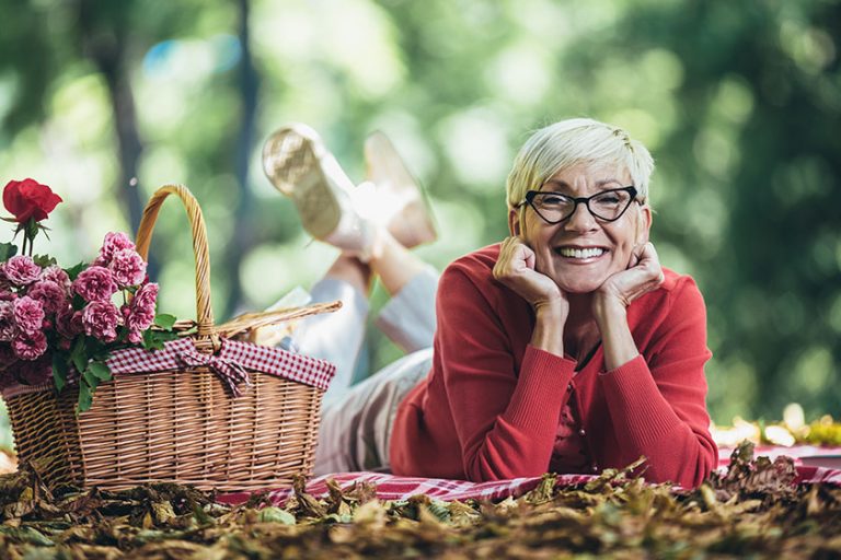 Portrait of senior woman at picnic in park