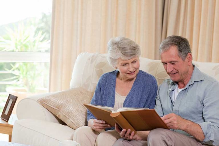 Seniors looking at their photo album Seniors looking at their photo album