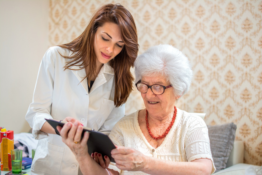 Female doctor or nurse discussing reports with senior patient. H The Importance Of Amenities In Palm Springs, FL Senior Independent Living