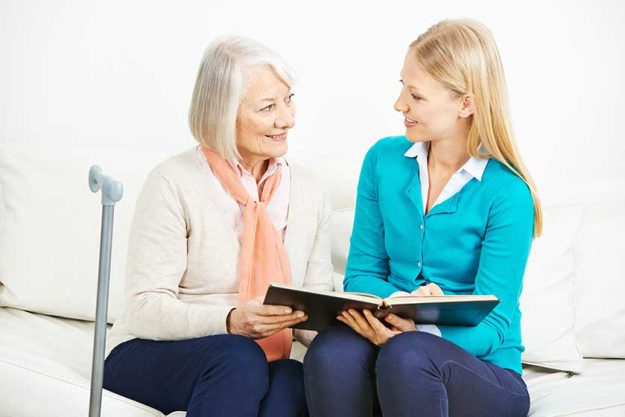 Woman and senior woman with photo album