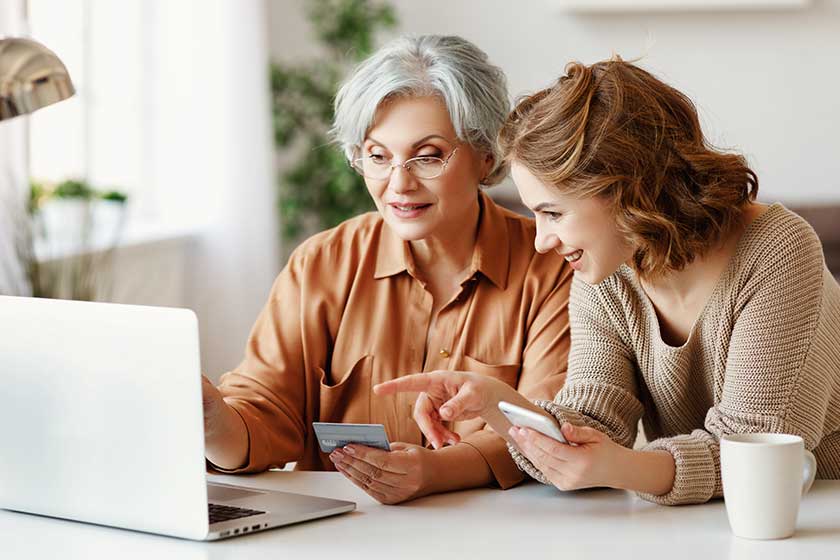 Young woman teaching senior mother to do online shopping. Young woman teaching senior mother to do online shopping.