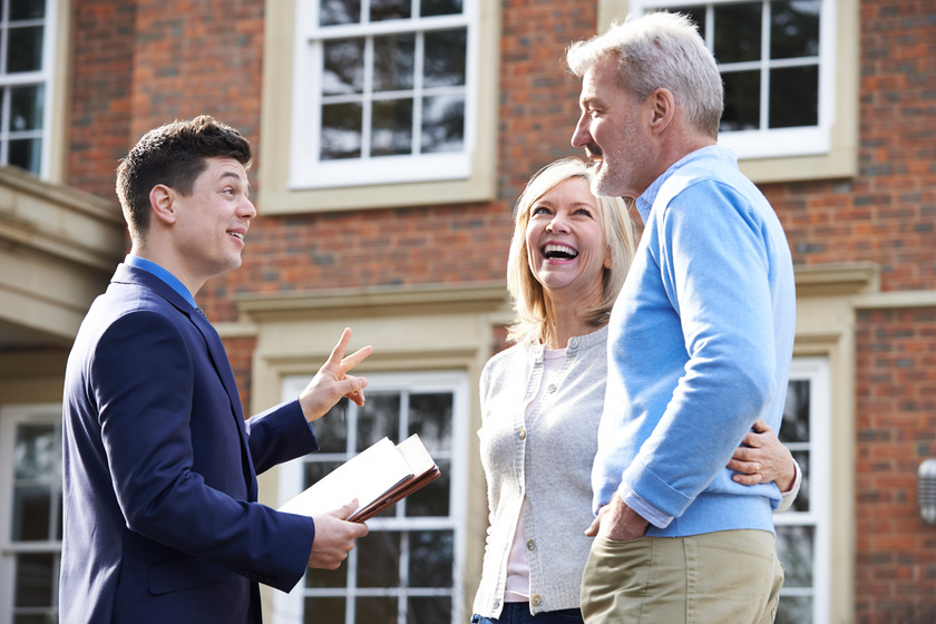 Realtor Showing Mature Couple Around House For Sale Realtor Showing Mature Couple Around House For Sale