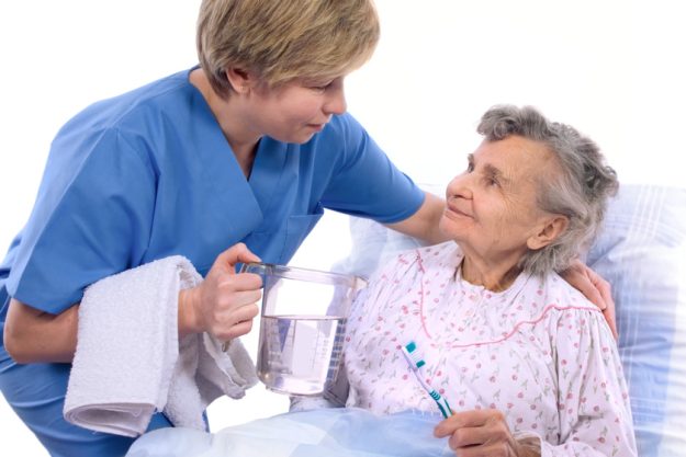 Nurse helps the senior woman in washing Nurse helps the senior woman in washing