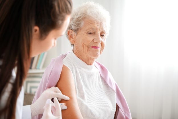 Doctor giving diabetic woman insulin injection at home Doctor giving diabetic woman insulin injection at home