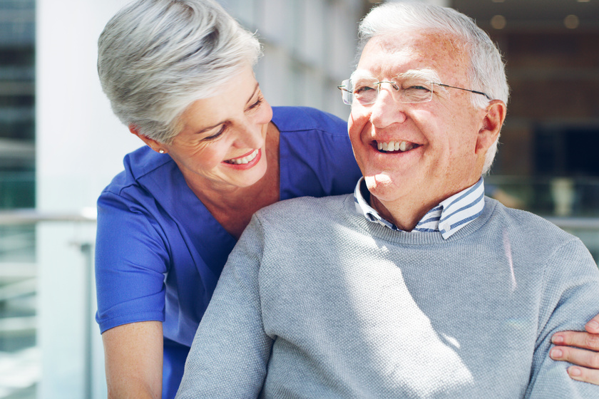 Always laugh when you can, its free medicine. Cropped shot of a happy senior man sitting in a wheelchair while his attractive mature nurse aid assists him indoors.