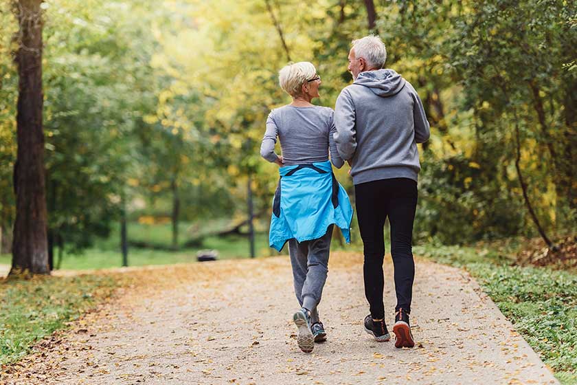 Cheerful active senior couple jogging in the park. Exercise together to stop aging Cheerful active senior couple jogging in the park. Exercise together to stop aging