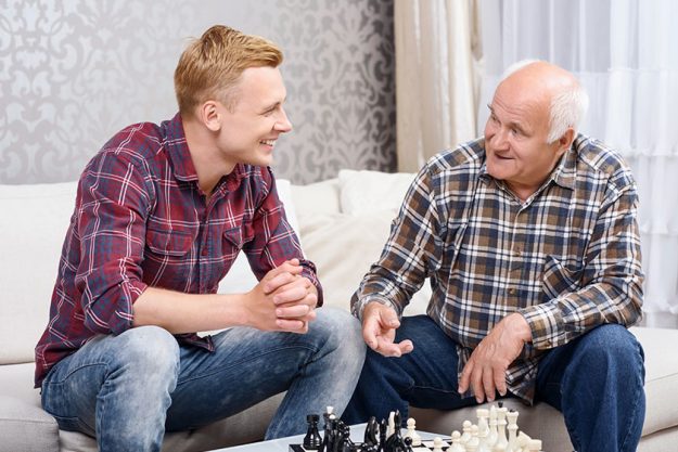 Grandfather and grandson playing chess