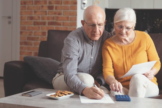 Senior couple paying bills together How To Pay For An Elderly Care Community In Vero Beach, FL: Some of Your Options