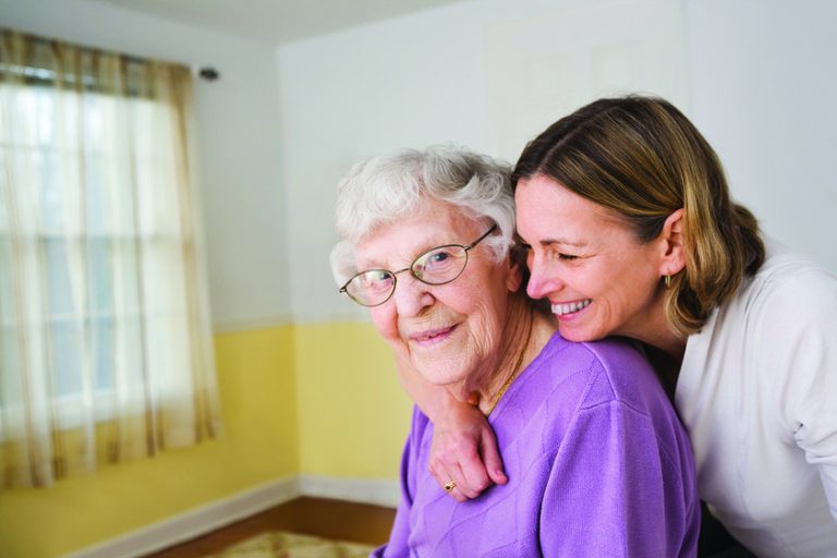 Daughter hugging Elderly mother