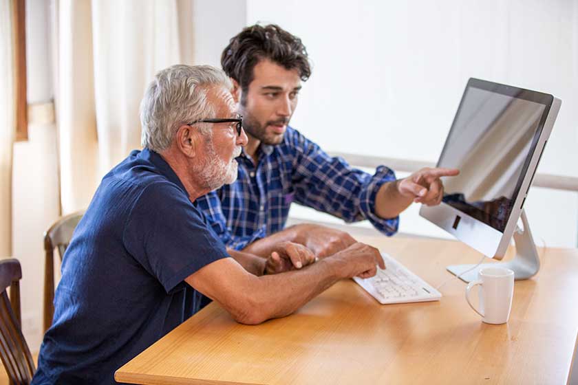 man teaching elderly man to using computer man teaching elderly man to using computer