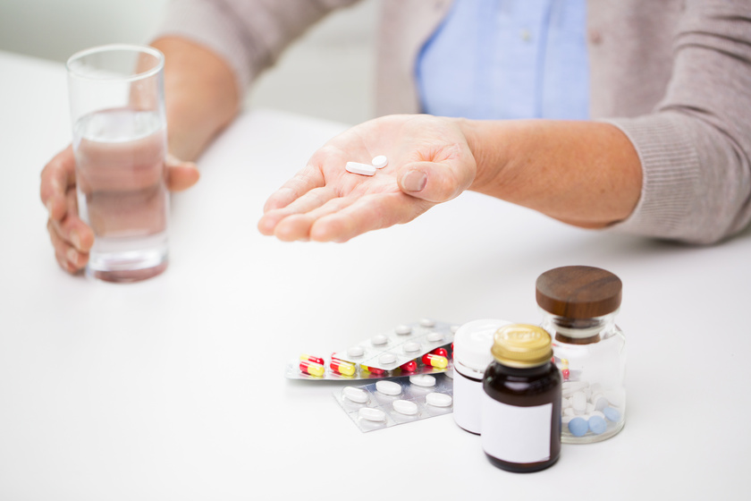 close up of senior woman with pills and water Managing Medication In Seniors: How Memory Care In Quantico, VA Can Help