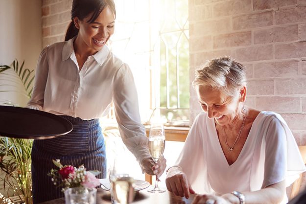 Restaurant, waitress and senior woman wine tasting for luxury, celebration