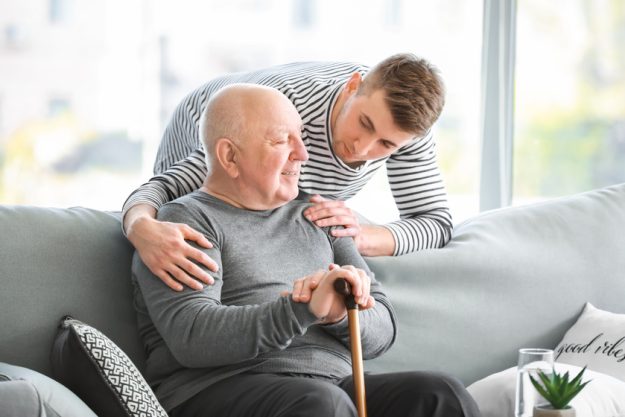 Male caregiver with senior man in nursing home The Importance Of Rent Protection Services In Collier County, FL Senior Community