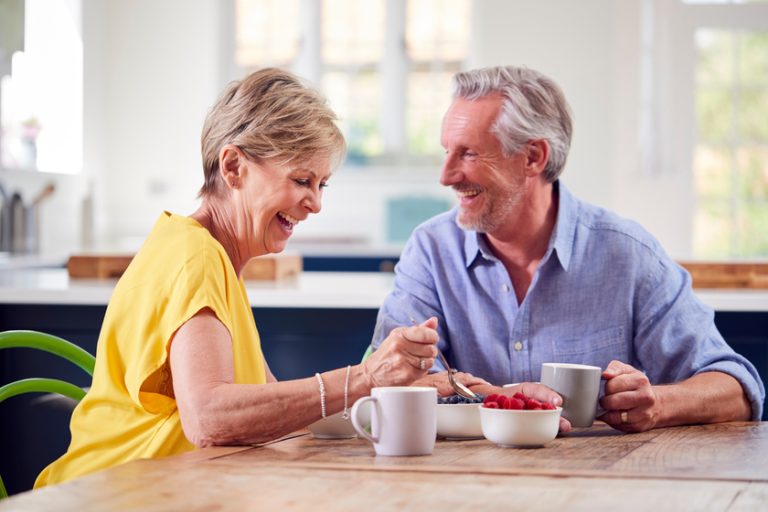Retired Couple Sitting Around Table At Home Having Healthy Break What To Expect In A Regular Day In Independent Senior Living In Bonita Springs, FL