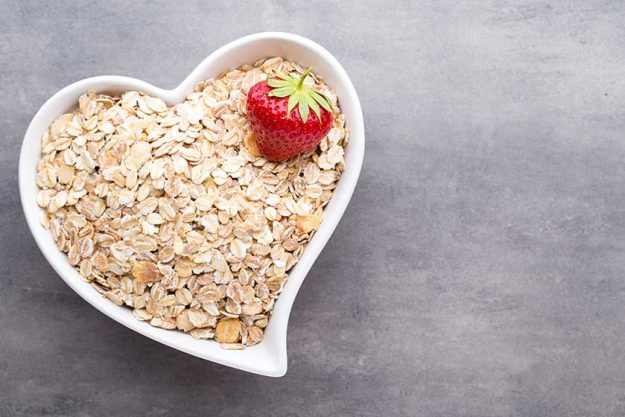 Dry rolled oatmeal in bowl. Dry rolled oatmeal in bowl.