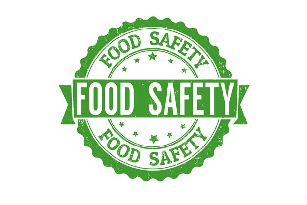 Green rubber stamp with food safety concept Green rubber stamp with food safety concept