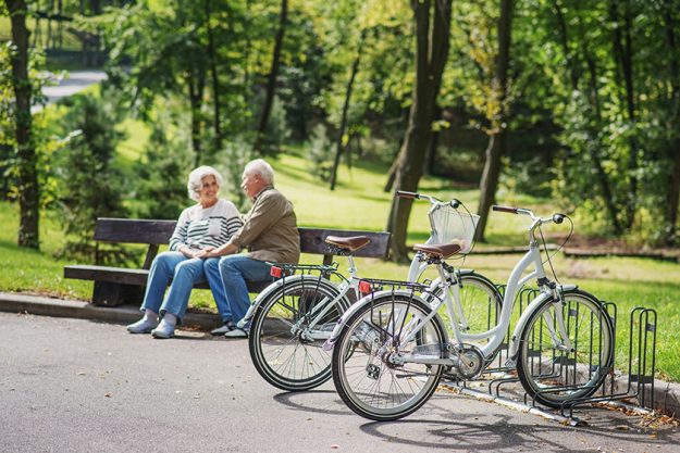 Mature man and woman resting after cycling Mature man and woman resting after cycling