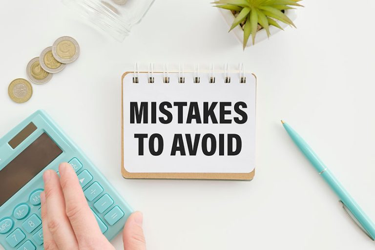 tepad with text Mistakes To Avoid lying on financial tables with a pen tepad with text Mistakes To Avoid lying on financial tables with a pen