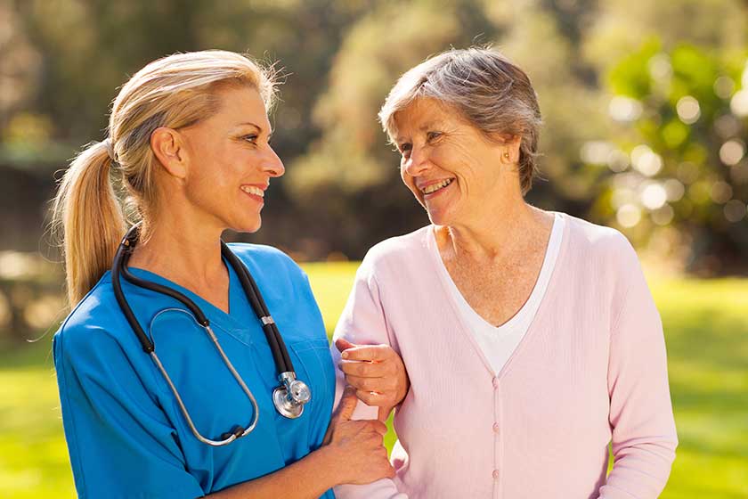 nurse talking to senior woman outdoors nurse talking to senior woman outdoors