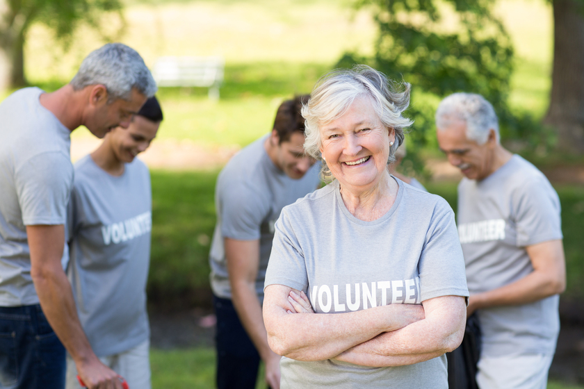 Happy volunteer grandmother smiling at camera on a sunny day