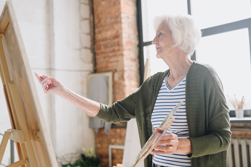 Senior Woman Painting in Art Studio