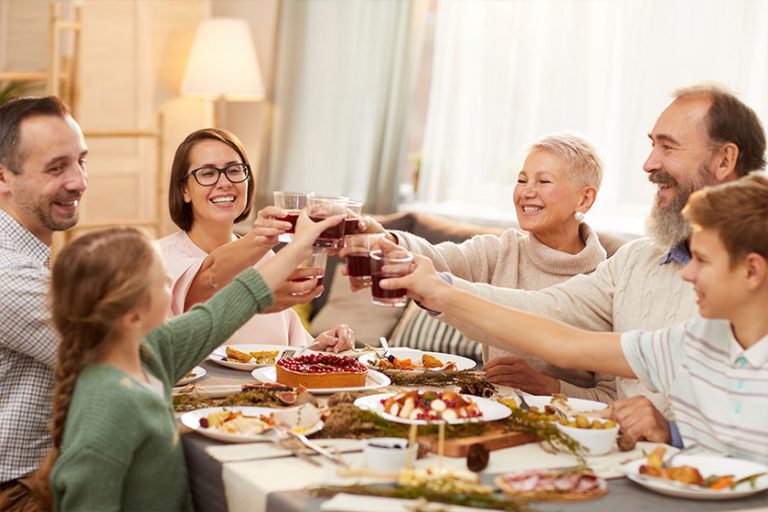 Happy Big Family Sitting Dining Table Toasting Red Wine Together