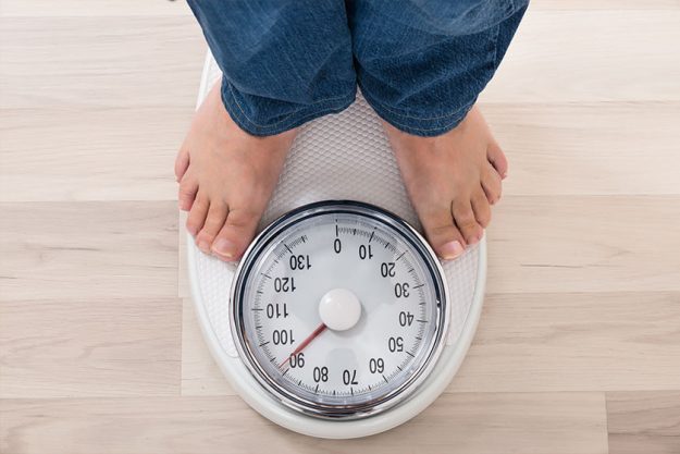Person Standing On Weighing Scale Person Standing On Weighing Scale