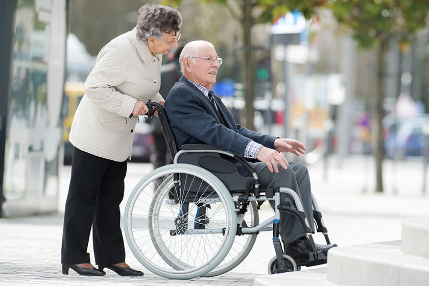 senior couple in wheelchair enjoying a day in the city