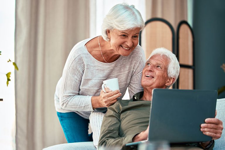 Senior couple, laptop and happy at Senior couple, laptop and happy at