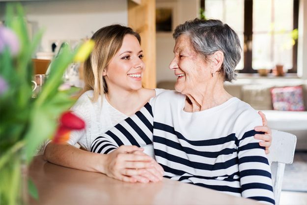 An elderly grandmother with an adult granddaughter