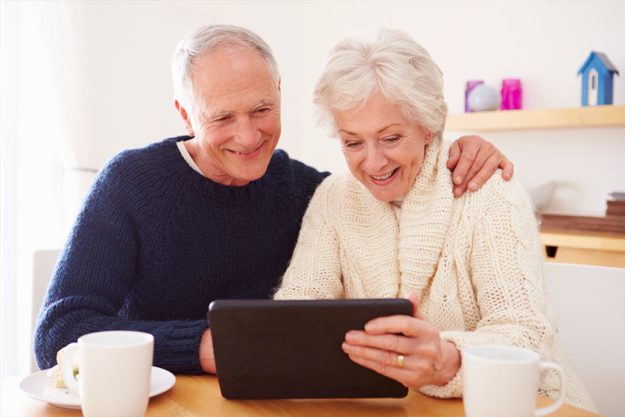 Content senior couple using a digital tablet Content senior couple using a digital tablet