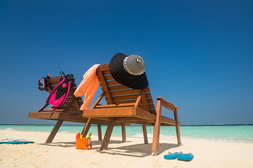 Deck chair at the tropical sandy beach