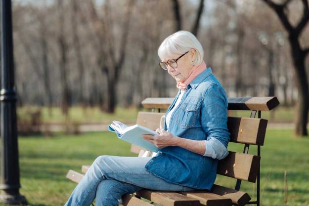 Determined old woman reading a book