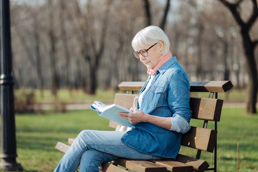 Determined old woman reading a book